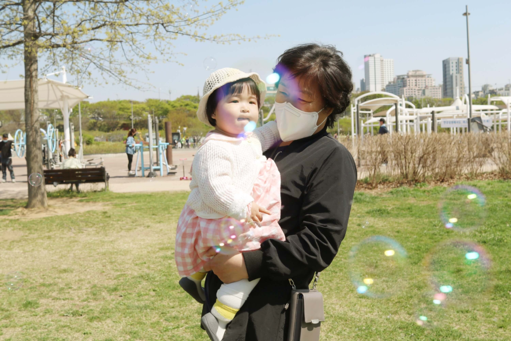 randparents, and a child relaxing together at Hangang Park