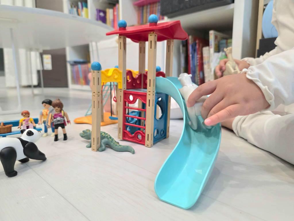 A child creating stories with Playmobil Happy Meal toy figures