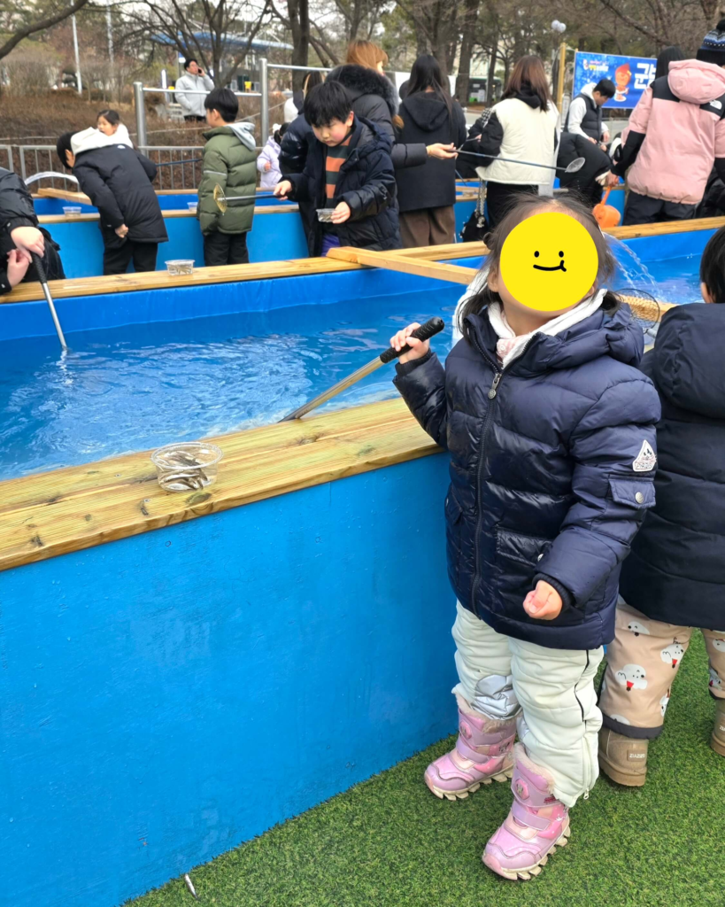 Kid having fun at a winter fishing in Korea