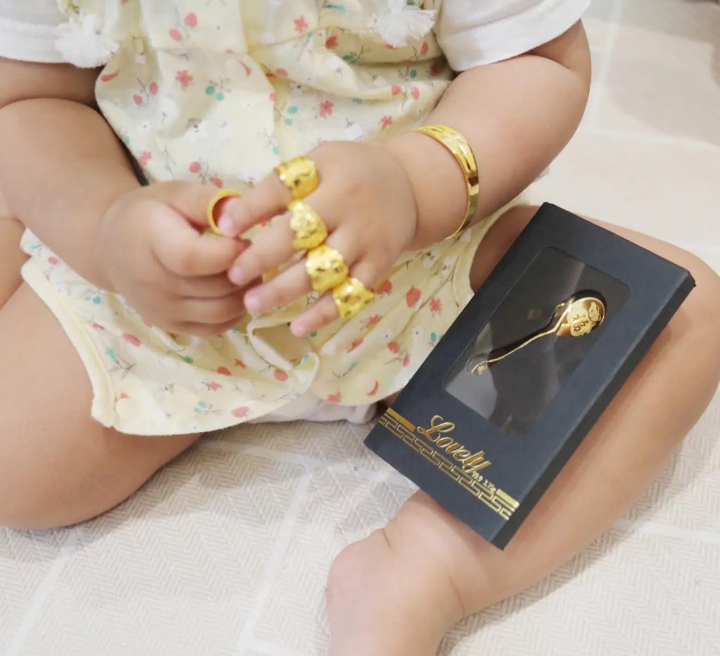 Baby wearing a gold ring received at a Doljanchi