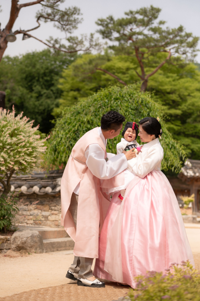 Traditional Korean first birthday party (doljanchi) with parents and baby