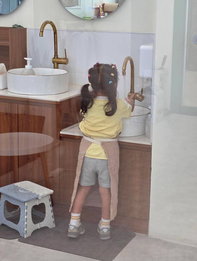 child washing hands before cooking