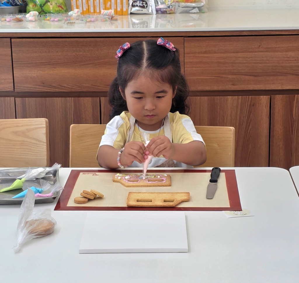 child focused on cookie decorating
