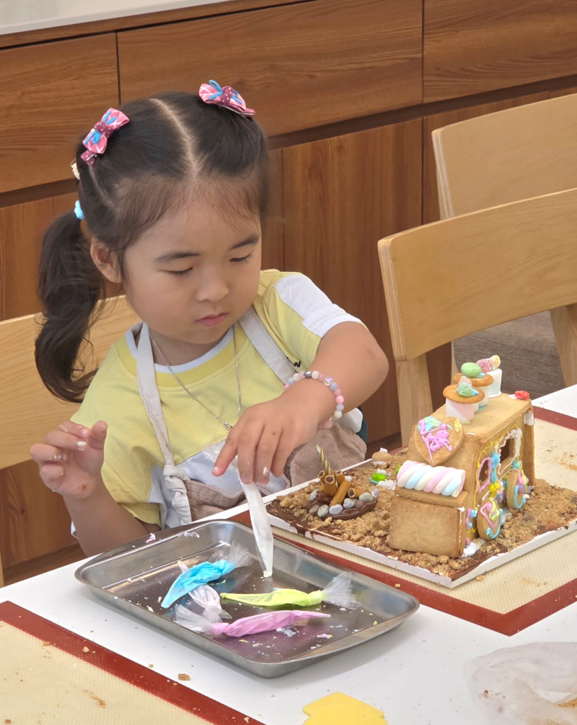 child decorating cookie camping car