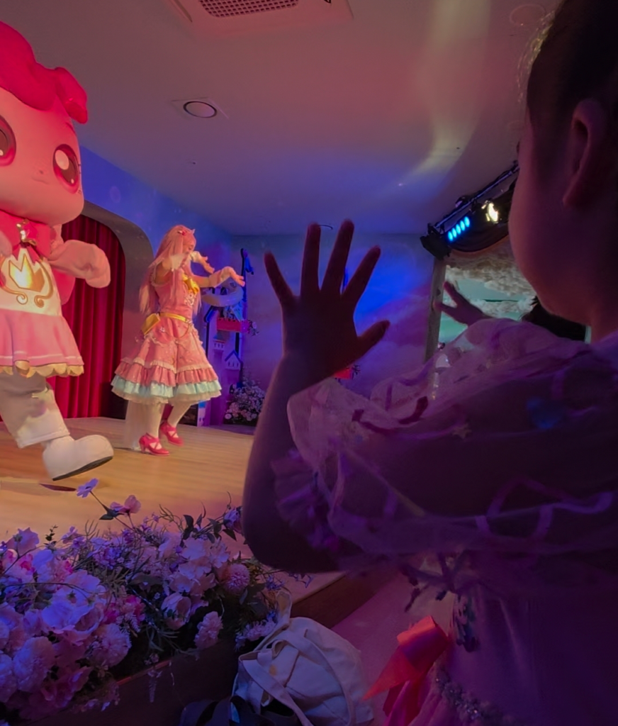 Child dancing during Teenieping performance front row