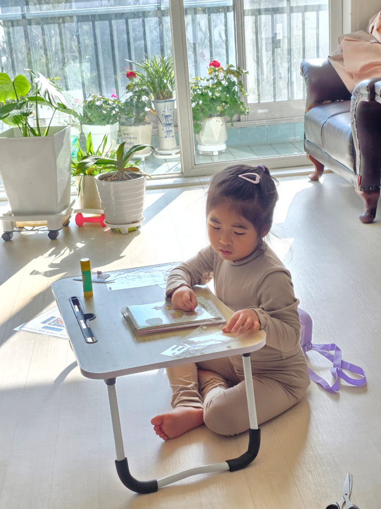 Child thinking about where to place the miniature 3D stickers