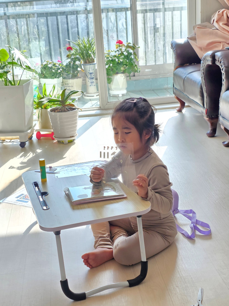 Child concentrating while deciding where to place the tiny stickers