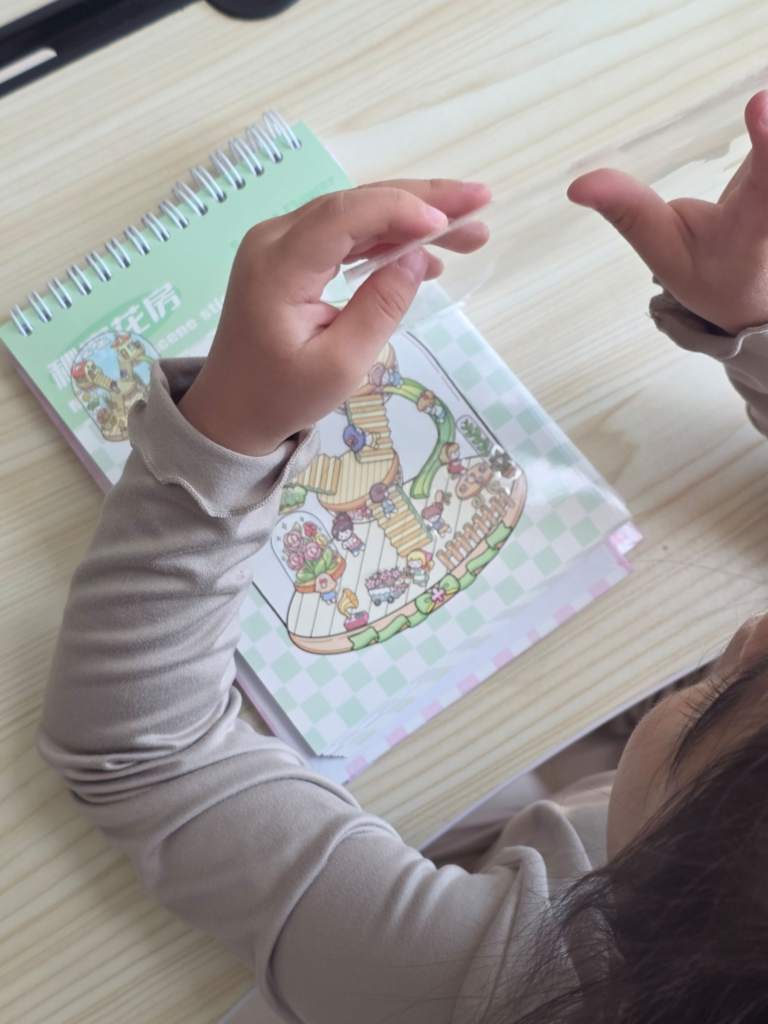 Kid carefully removing a small sticker from the backing