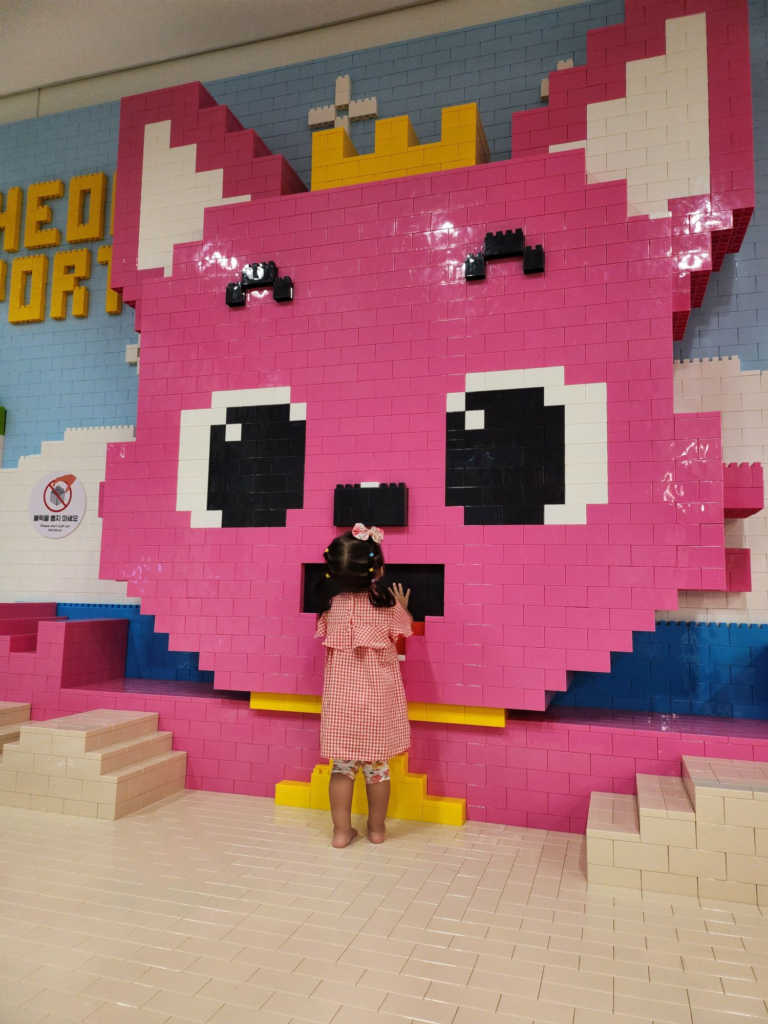 toddler playing with Pinkfong at the airport before boarding