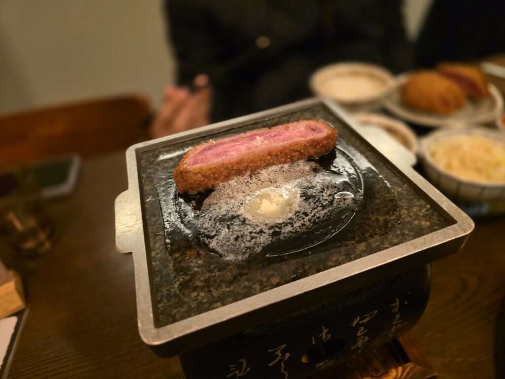 cooking beef cutlet on a personal grill in a Seoul restaurant