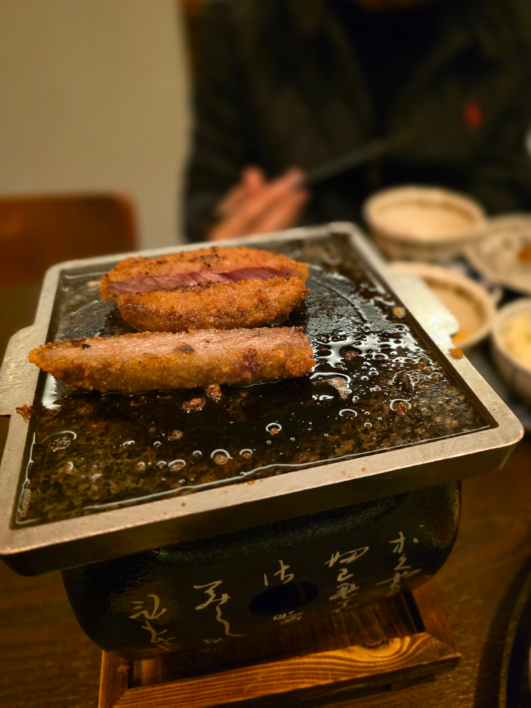 grilling gyukatsu on a mini grill at Gyuendang in Seongsu