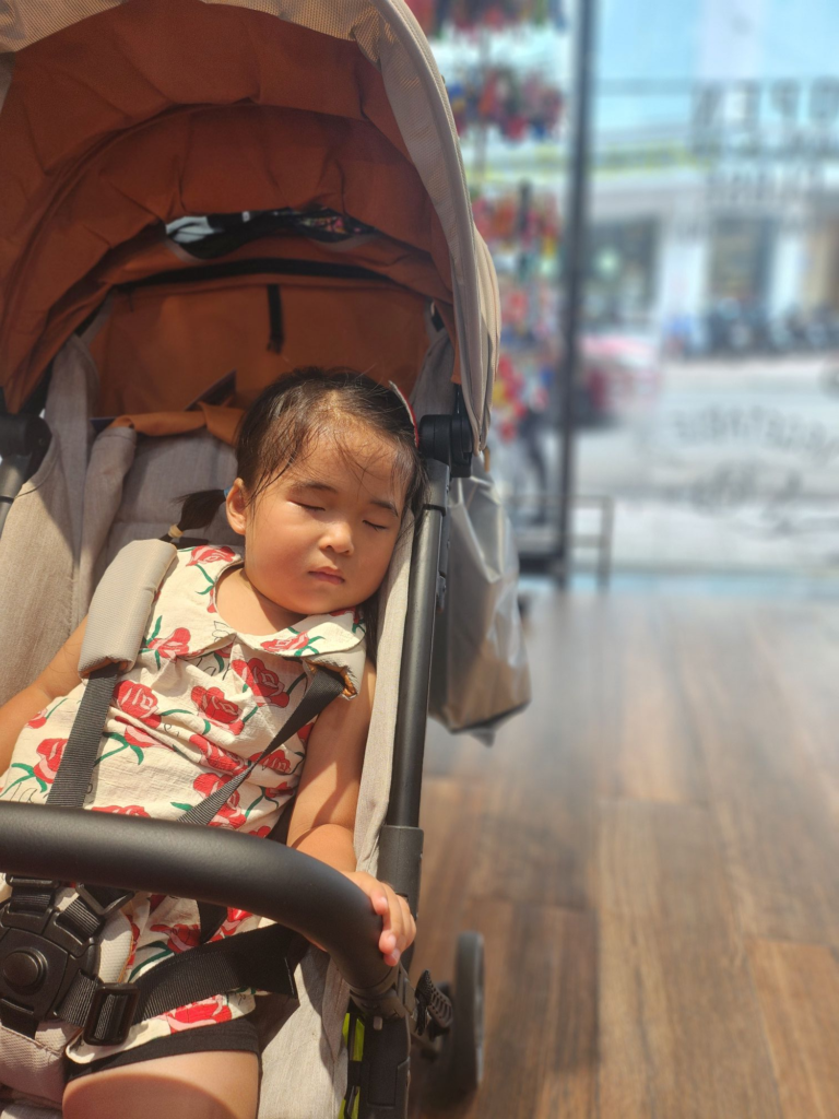 toddler sleeping in a stroller at the airport