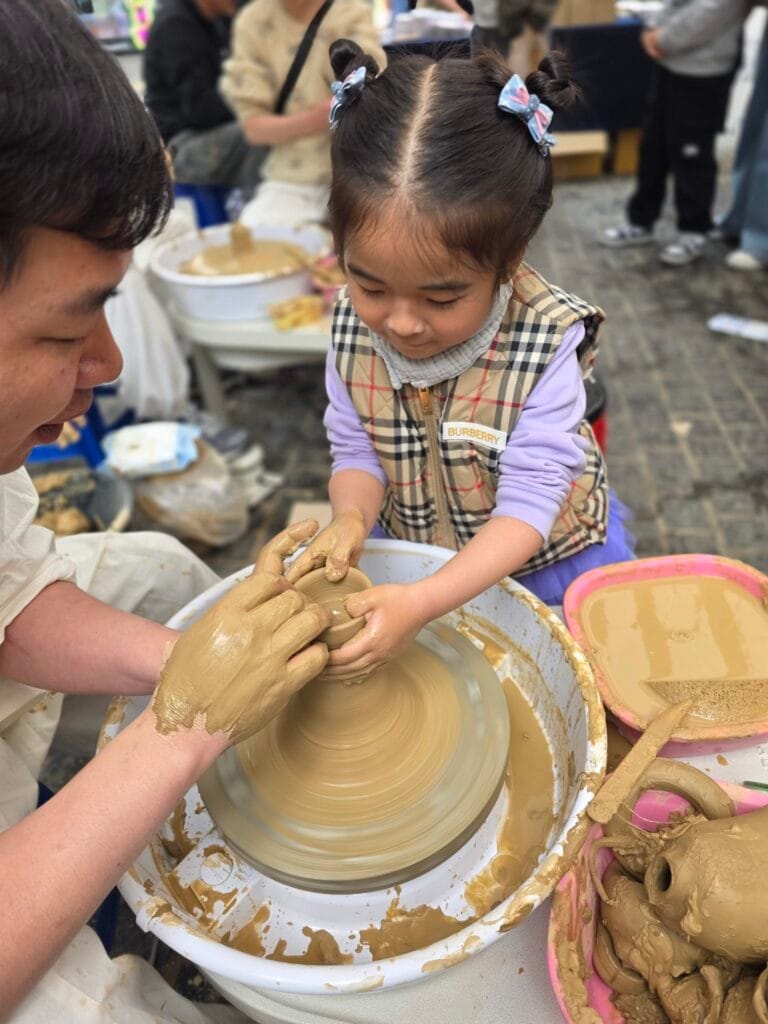 child trying pottery wheel Korea